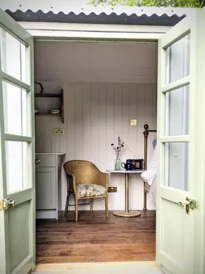 an open door to a room with a chair and a table at The Applehay in Constantine