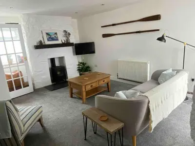 a living room with a couch and a fireplace at Foundry cottage in Hayle
