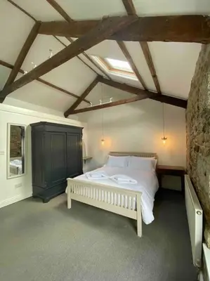 a bedroom with a white bed in a room at Foundry cottage in Hayle