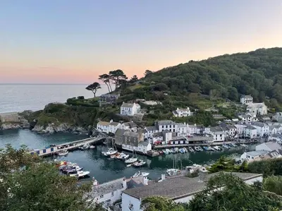 a group of boats docked in a harbor at Crow's Nest, Polperro in Polperro