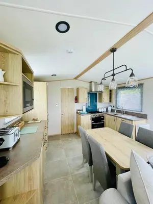 a kitchen and dining room with a wooden table at Holiday Home with Stunning Views in Newquay