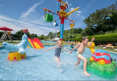 two young boys are playing in a water park at Holiday Home with Stunning Views in Newquay