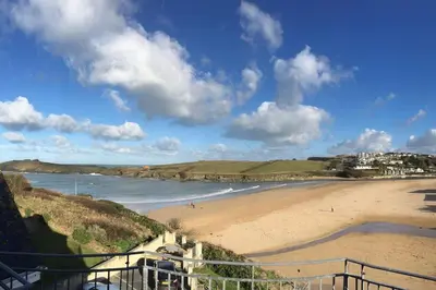 a view of a beach with people in the water at Beach Side Top Floor Property, Balcony & Sea Views in Newquay