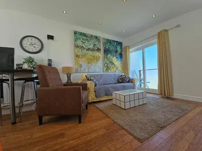 a living room with a couch and a table at Ocean Swell (49) in Bude