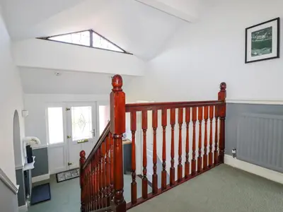 a staircase in a house with a skylight at Newquay Tamarisk Lodge on the Gannel in Newquay