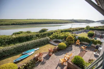an aerial view of a garden with a boat in it at Newquay Tamarisk Lodge on the Gannel in Newquay