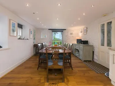 a kitchen and dining room with a table and chairs at Glenside House in Carbis Bay