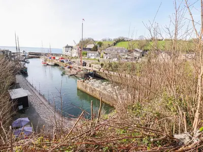 a group of boats docked in a body of water at Spinnaker in St Austell