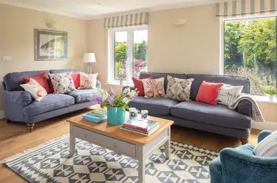 a living room with two couches and a coffee table at High Meadows in Saint Mawes