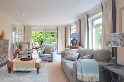 a living room with a couch and two chairs at High Meadows in Saint Mawes