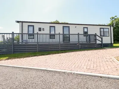 a house with a fence and a brick driveway at 63 The Maples in St Austell
