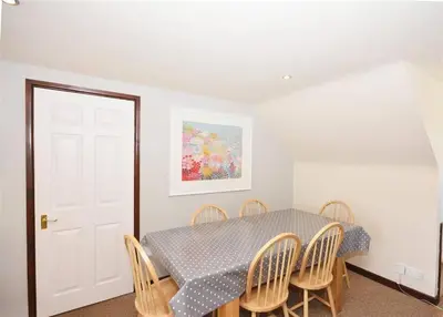 a dining room with a table and chairs at Direct Beach Access! Top Floor Apartment Perranporth in Perranporth