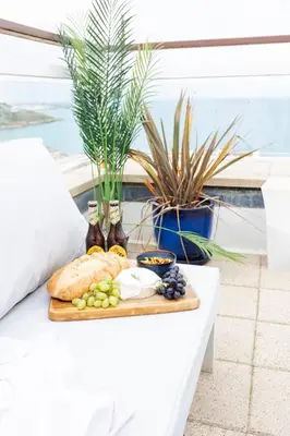 a tray of food on a table with a plate of food at NEW! Stunning 2 Bed Beach Front Penthouse Apartment - Topaz, Compass Point in Carbis Bay