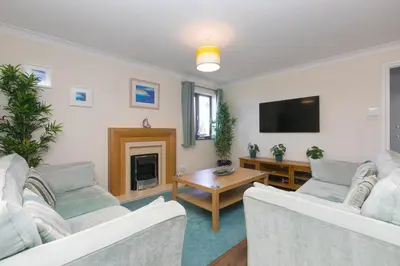 a living room with two couches and a tv at Spernenwyn in St Ives