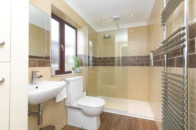 a bathroom with a toilet and a sink and a shower at Spernenwyn in St Ives
