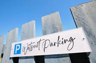 a sign that reads p fastest parking on a wooden fence at Sunset View, near Gwithian & St.Ives Bay in Gwithian