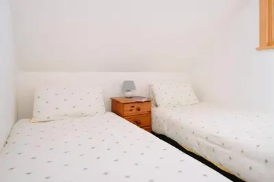 two beds sitting next to each other in a bedroom at Sunset View, near Gwithian & St.Ives Bay in Gwithian