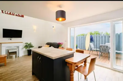 a living room with a table and chairs and a living room at Sunset View, near Gwithian & St.Ives Bay in Gwithian