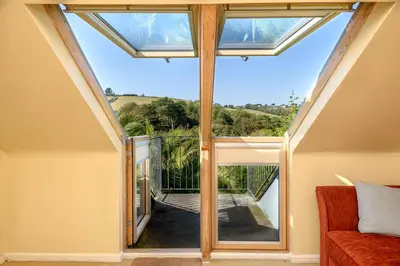 an internal view of a conservatory with a glass roof at Beach Front House with Stunning Sea Views and Free Use of a Local Indoor Pool in Talland
