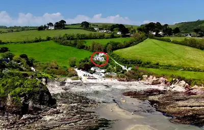 an aerial view of a house in a field at Beach Front House with Stunning Sea Views and Free Use of a Local Indoor Pool in Talland