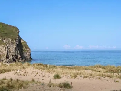a beach with the ocean and a cliff at 16 Seaspray in Truro