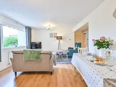 a living room with a table and a couch at Apartment Rock Pools by Interhome in Mevagissey
