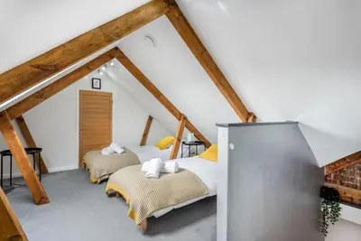 a bedroom with two beds in a attic at Spacious, Modern Home, Central Newquay w/ parking in Newquay