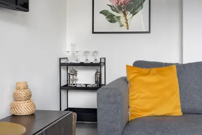 a living room with a gray couch and a yellow pillow at Spacious, Modern Home, Central Newquay w/ parking in Newquay