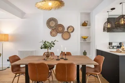 a dining room with a wooden table and chairs at Stylish & Modern Home, Central Newquay w/parking in Newquay