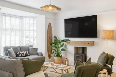 a living room with a couch and a tv at Stylish & Modern Home, Central Newquay w/parking in Newquay