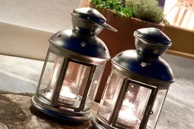 two black and silver lanterns sitting on a table at Nearwater in Saint Mawes