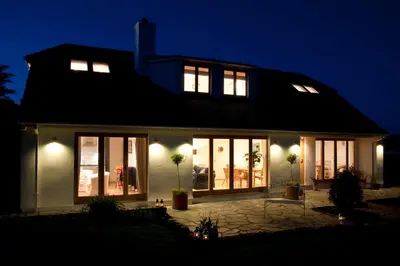 a house lit up at night with lights at Nearwater in Saint Mawes