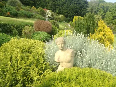 a statue of a man in a garden at Polraen Country House Hotel in Looe
