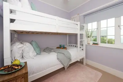 a white bunk bed in a room with a window at Mermaid Cottage, Carbis Bay in Carbis Bay