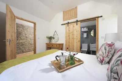 a bedroom with a bed with a tray with a pitcher on it at Relaxing getaway with a Hot Tub, Wi-Fi in Bodmin