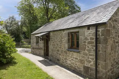 an old stone building with a window on it at Relaxing getaway with a Hot Tub, Wi-Fi in Bodmin