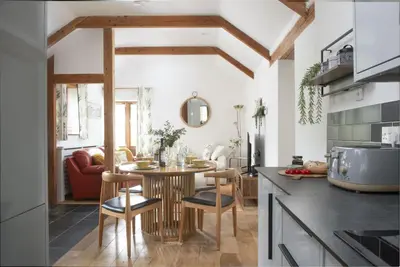 a kitchen with a table and chairs in a room at Relaxing getaway with a Hot Tub, Wi-Fi in Bodmin