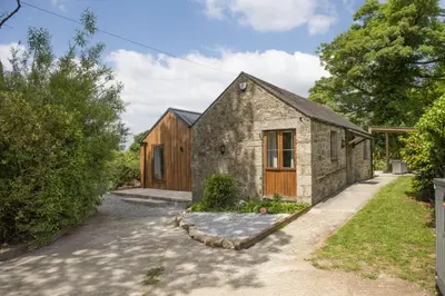an old stone house with a wooden door at Relaxing getaway with a Hot Tub, Wi-Fi in Bodmin