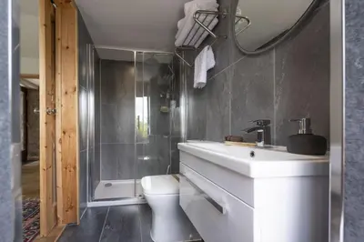 a bathroom with a white sink and a toilet at Relaxing getaway with a Hot Tub, Wi-Fi in Bodmin
