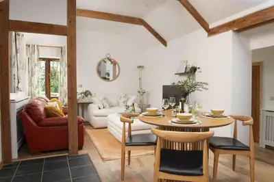 a living room with a table and a couch at Relaxing getaway with a Hot Tub, Wi-Fi in Bodmin