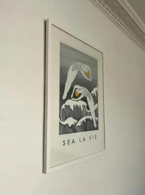 a framed picture of two birds on a wall at Contemporary 3-Bedroom Home with Stunning Views in Looe