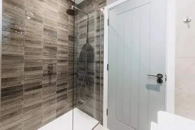 a bathroom with a shower with a glass door at 3 Bed in Hayle oc-t27597 in Hayle