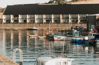 a group of boats docked in the water in front of a building at 3 Bed in Hayle oc-t27597 in Hayle