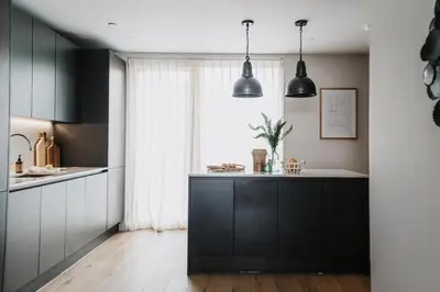 a kitchen with black cabinets and a kitchen island at 3 Bed in Hayle oc-t27597 in Hayle