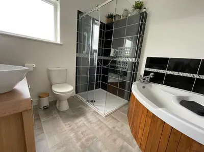 a bathroom with a tub and a toilet and a sink at Chy An Lur in Redruth