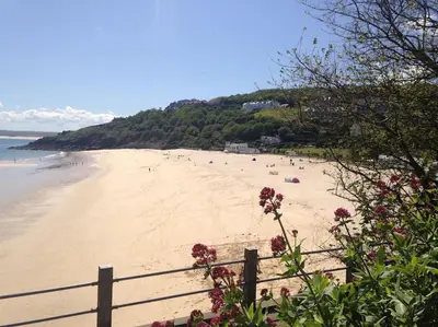 a view of a beach with people on it at Riverside Apartment in Uny Lelant
