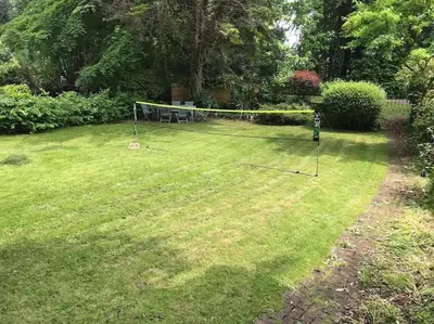 a yard with a net in the grass at Riverside Apartment in Uny Lelant
