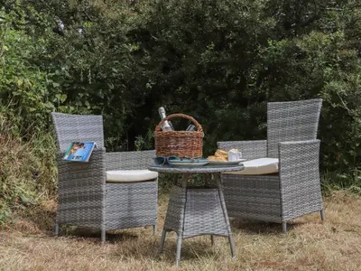 a table and chairs with a basket on top of it at The Hayloft in Helston