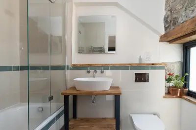 a bathroom with a sink and a shower at The Rum House in Helston