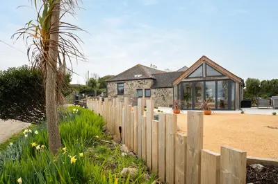 a wooden fence in front of a house at The Rum House in Helston